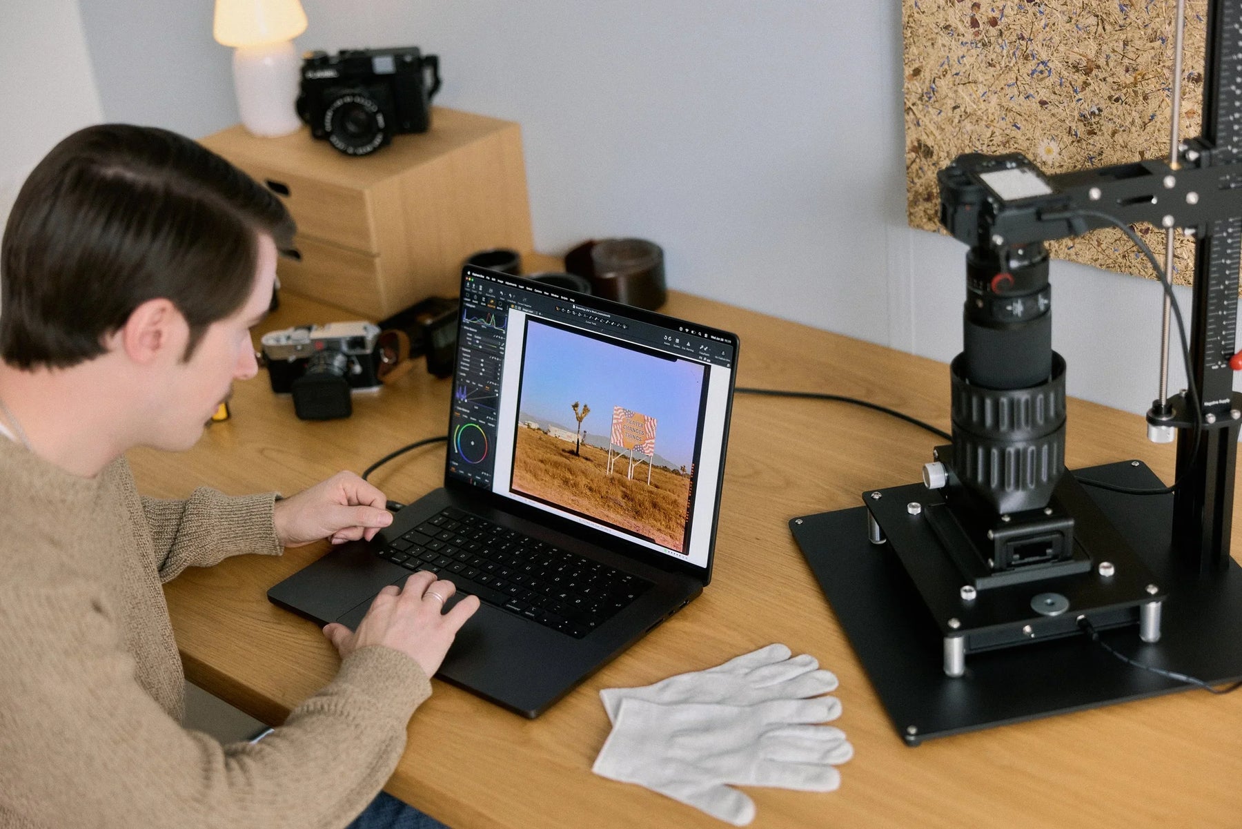 Reviewing a digitised film photograph on a laptop beside a Negative Supply camera-scanning setup