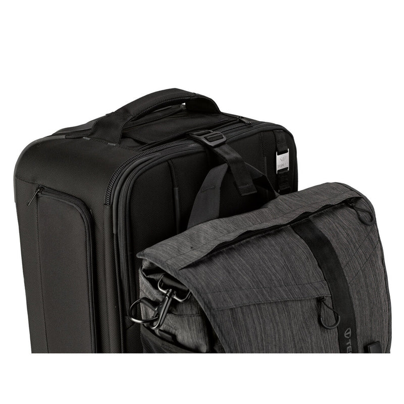 An image of the Tenba Roadie Roller 24 Black roll along case for storing cameras and photographic equipment. A strap is used to attach a shoulder bag so that the case can be rolled along with the bag attached.