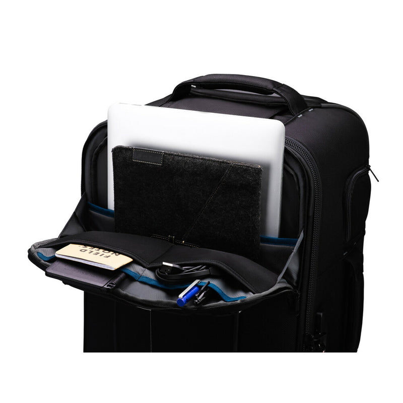 An image of the Tenba Roadie Roller 24 Black roll along case for storing cameras and photographic equipment showing an open zipped pocket containing a laptop and stationery.