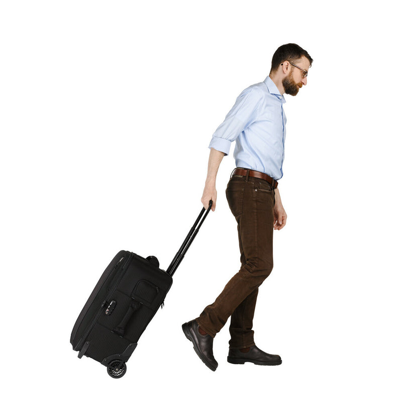 An image of a photographer rolling the Tenba Roadie Roller case.