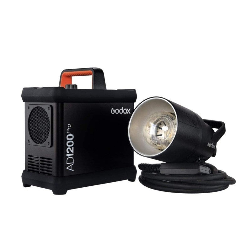 An image of the Godox AD1200Pro TTL Battery Flash Power Pack Kit which contains the Godox AD1200Pro Flash, power pack, 5200mAh battery, 3.65m cable, charger, reflector, glass lamp cover, rolling case, carry case and power cable. The studio flash is pictured next to the power pack which has a carry handle.