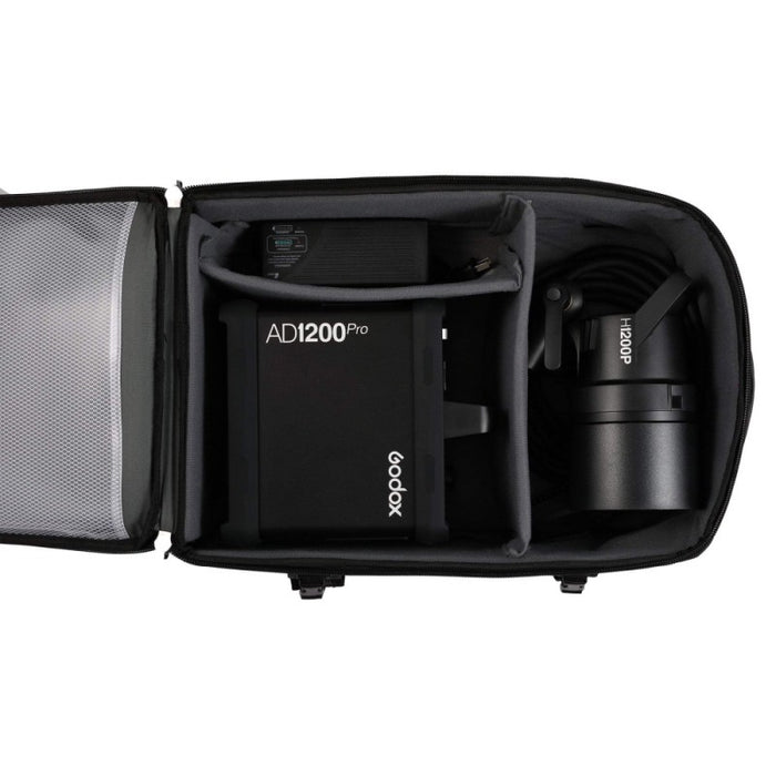 An image of the inside of the carry case for the Godox AD1200Pro TTL Battery Flash. It shows the flash light in one compartment and the charger and power pack in a separate compartment for protecting the photography equipment during transport.