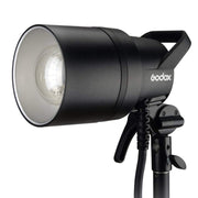 An image of the Godox AD1200Pro TTL Battery Studio Flash Light. The light features a handle on the back for portability and is pictured mounted on a light stand.