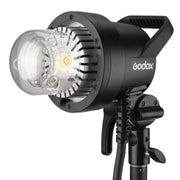 An image of the Godox AD1200Pro TTL Battery Studio Flash Light. The light features a handle on the back for portability and is pictured mounted on a light stand.