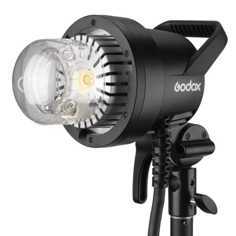 An image of the Godox AD1200Pro TTL Battery Studio Flash Light. The light features a handle on the back for portability and is pictured mounted on a light stand.